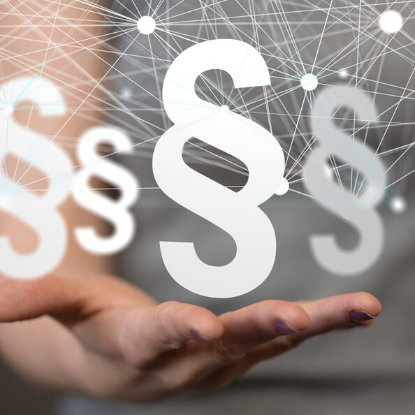 Bild zeigt Paragraph-Zeichen und eine Hand